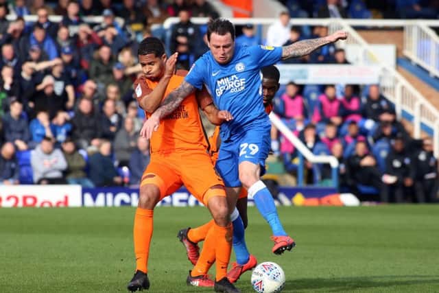Lee Tomlin of Posh battles for possession with Southend's Timothee Dieng. Photo: Joe Dent/theposh.com.