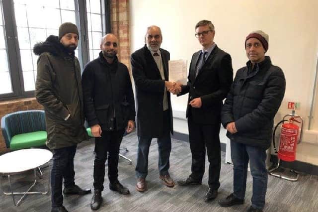 Cllr Ansar Ali handing over the petition against the plans