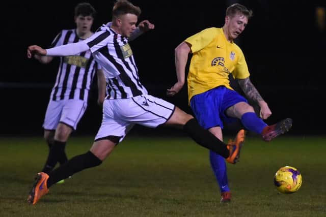 Jake Sansby of Peterborough Northern Star (stripes) in action against Pinchbeck United. Photo: Chantelle McDonald. @cmcdphotos.