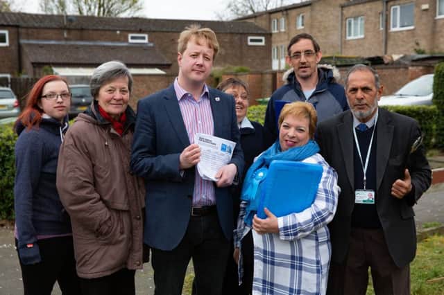 Paul Bristow (holding the petition), Angie Fenner and Cllr Gul Nawaz with residents. Photo: Terry Harris