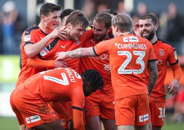 Luton Town's Luke Berry (second left) is congratulated by team-mates after scoring.