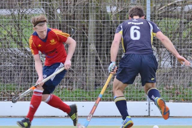 Ross Ambler (red) scored for City of Peterborough against Cambridge City.