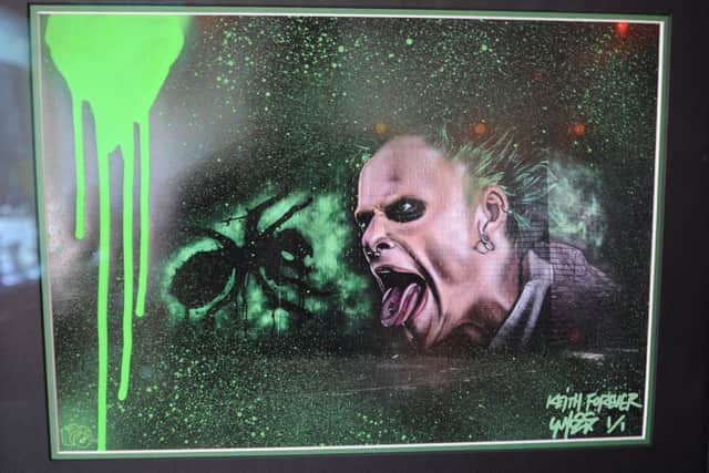 Nathan Murdock with his streetart framed painting  of Keith Flint which is to be auctioned by  Martin Rowe, DJ, Eve Warner, owner of The Lightbox and Zed Malik in aid of MIND EMN-190329-173622009