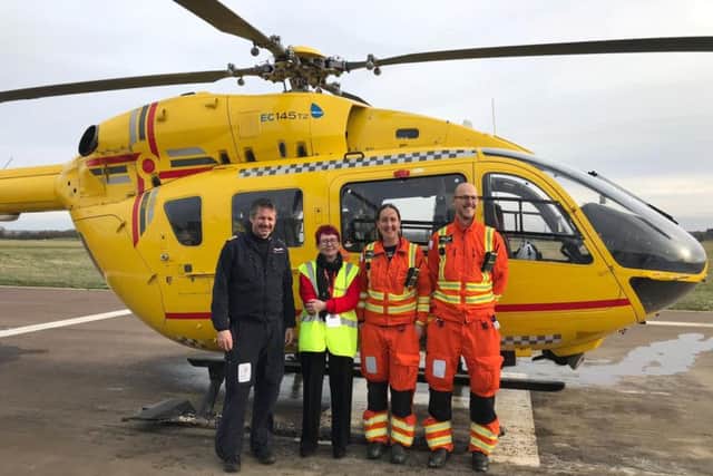 Sue with pilot Martin Polding (left), Dr Antonia Hazlerigg and a paramedic from the East Anglian Air Ambulance. Photo: SWNS