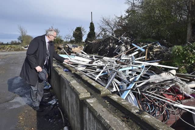 Cllr John Holdich surveys some of the fly-tipping at Norwood Lane