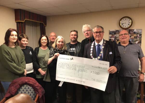 The Nene and Welland Branch of the Oddfellows presents its cheque to staff and volunteers at Deepings Youth Group.