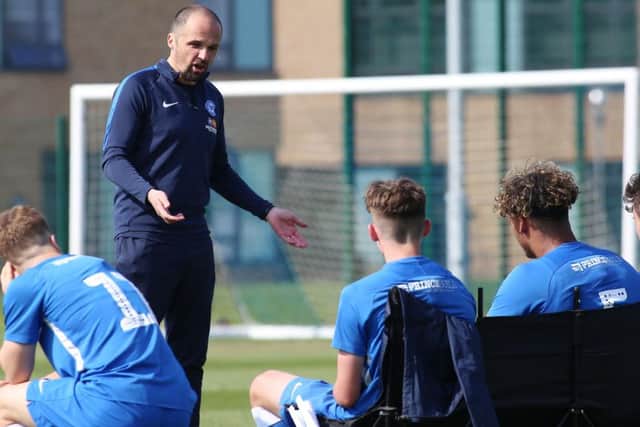 Posh under 18 manager Matthew Etherington addresses his players. Photo: Joe Dent/theposh.com.
