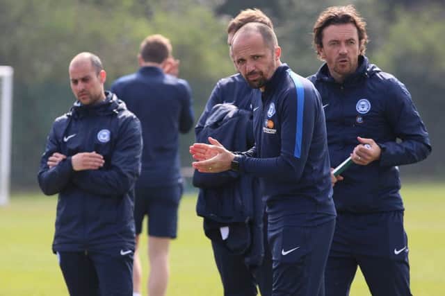 Matthew Etherington (centre) and Simon Davies (right) watch Posh under 18s. Photo: Joe Dent/theposh.com.