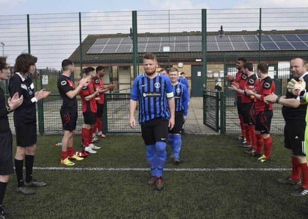 Pedterborough Premier Division champions Moulton Harrox are given a guard of honour by Nethertton United players and match officials. Photo: David Lowndes.