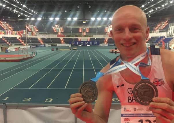 Dave Brown with his two medals at the World Indoor Masters Championships in Poland.