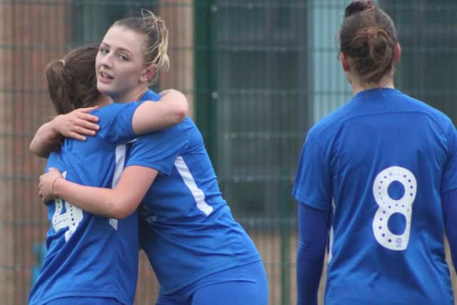 Six goal Hannah Pendred gets a hug from her captain Keir Perkins. Picture: Gary Reed