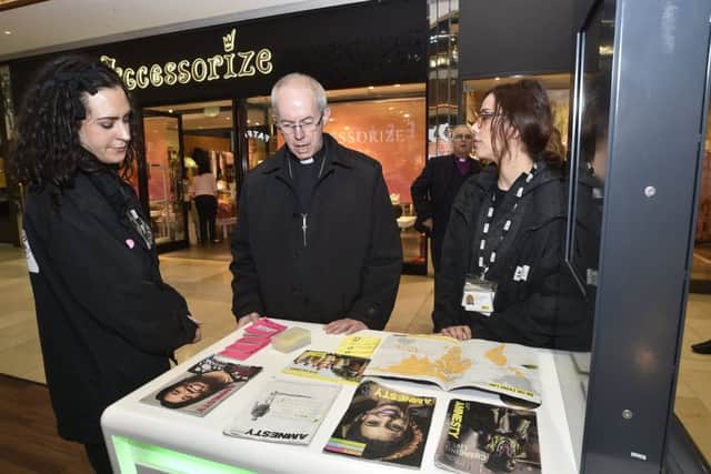 Archbishop of Canterbury Justin Welby visiting Peterborough with Bishop of Peterborough  Rt Revd. Donald Allister, The Vicar of Peterborough Revd Canon Ian Black and Harry Traynor, assistant centre manager , during a tour of Queensgate