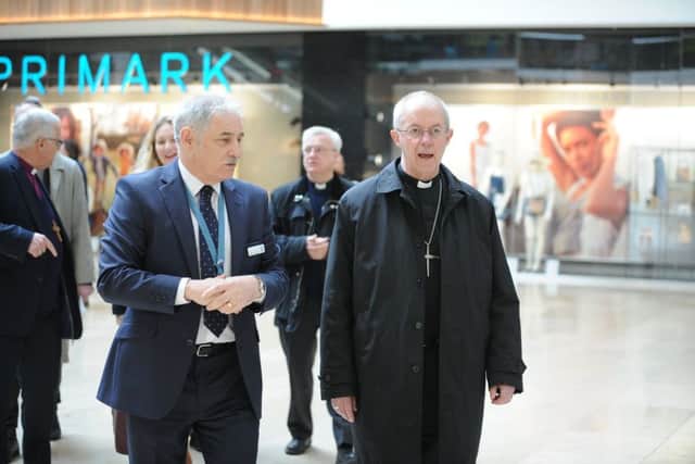 Archbishop of Canterbury Justin Welby visiting Peterborough with Bishop of Peterborough  Rt Revd. Donald Allister, The Vicar of Peterborough Revd Canon Ian Black and Harry Traynor, assistant centre manager , during a tour of Queensgate