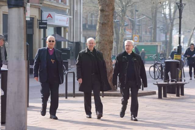 Archbishop of Cantebury Justin Welby visiting Peterborough with Bishop of Peterborough  Rt Revd. Donald Allister, The Vicar of Peterborough Revd Canon Ian Black and Harry Traynor, assistant centre manager , during a tiour of Queensgate Queensgate EMN-190804-114803009