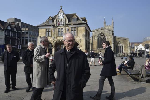 Archbishop of Canterbury Justin Welby visiting Peterborough with Bishop of Peterborough  Rt Revd. Donald Allister, The Vicar of Peterborough Revd Canon Ian Black and Harry Traynor, assistant centre manager , during a tour of Queensgate
