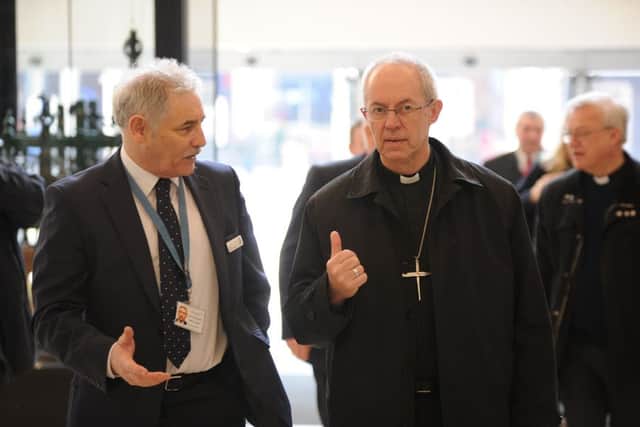 Archbishop of Canterbury Justin Welby visiting Peterborough with Bishop of Peterborough  Rt Revd. Donald Allister, The Vicar of Peterborough Revd Canon Ian Black and Harry Traynor, assistant centre manager , during a tour of Queensgate