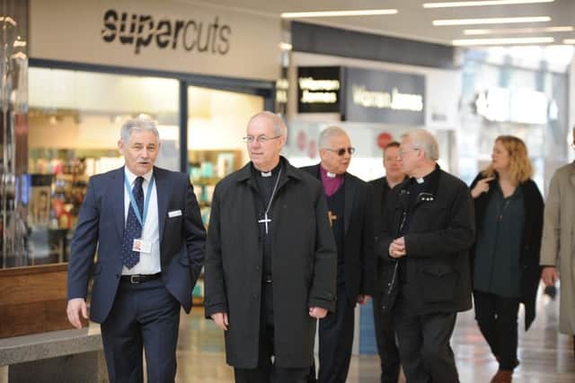 Archbishop of Canterbury Justin Welby visiting Peterborough with Bishop of Peterborough  Rt Revd. Donald Allister, The Vicar of Peterborough Revd Canon Ian Black and Harry Traynor, assistant centre manager , during a tour of Queensgate
