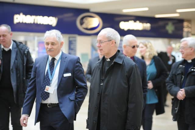 Archbishop of Canterbury Justin Welby visiting Peterborough with Bishop of Peterborough  Rt Revd. Donald Allister, The Vicar of Peterborough Revd Canon Ian Black and Harry Traynor, assistant centre manager , during a tour of Queensgate