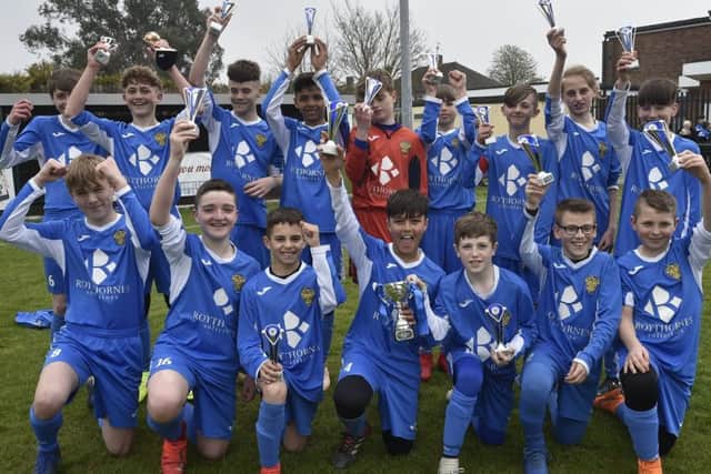Spalding United Blue Under 13s celebrate their League Cup success.
