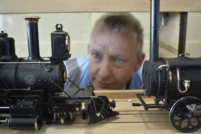 Alan Finch looking at some of the smaller models. EMN-190804-093531009