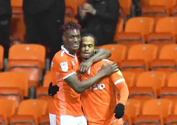 Blackpool top scorer Armand Gnanduillet (left) with teammate Nathan Delfouneso.