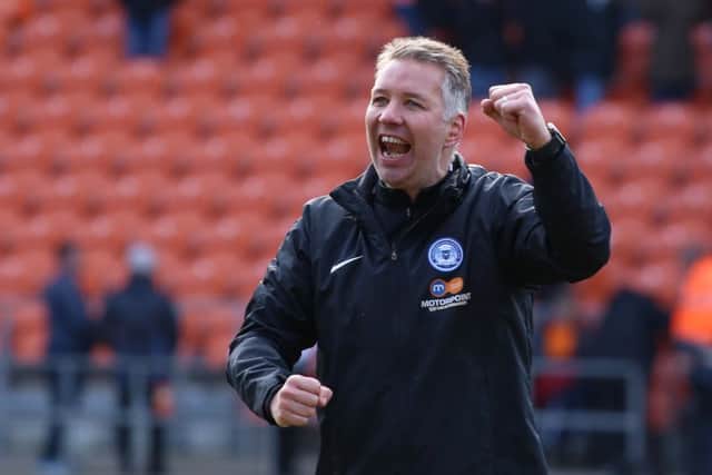 Peterborough United Manager Darren Ferguson celebrates the victory at Blackpool at full-time. Photo: Joe Dent/theposh.com.