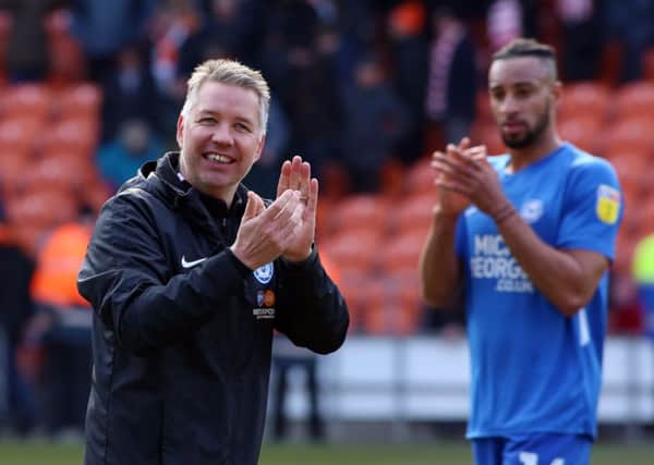 Posh manager Darren Ferguson and centre-back Rhys Bennett applaud the visiting fans after the 1-0 win at Blackpool. Photo: Joe Dent/theposh.com.