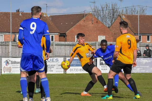 Henry Nkobi (blue shirt) scores Peterborough Sports' third goal against Aylesbury. Photo: James Richardson.