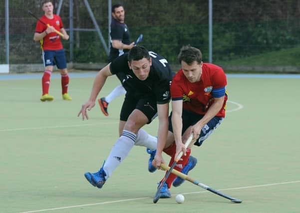 City of Peterborough skipper Ross Booth (red) battles for possession in the play-off match with Fareham. Photo: David Lowndes.