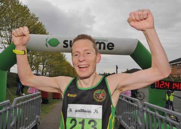 Ty Farrer celebrates his win in the Peterborough Marathon. Photo: David Lowndes.