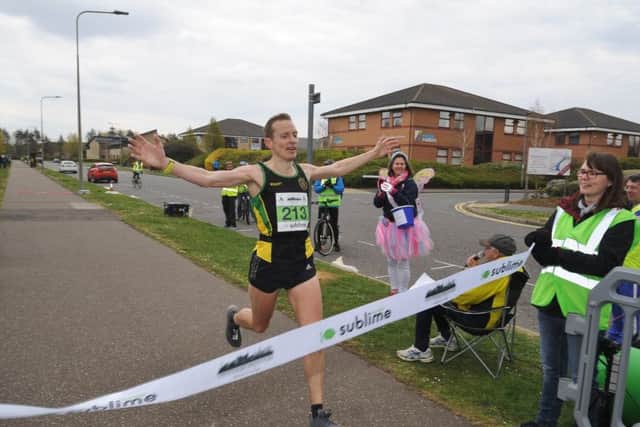 Winner Ty Farrer crosses the line first in the Peterborough Marathon. Photo: David Lowndes.