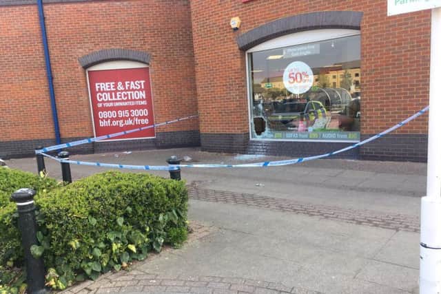 Police tape around the BHF store at the Rivergate Shopping Centre