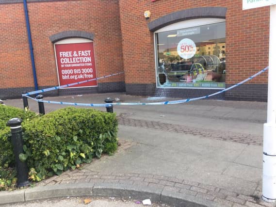 Police tape around the BHF store at the Rivergate Shopping Centre