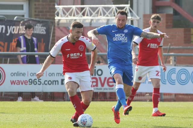 Posh player Lee Tomlin of Peterborough United in action with Lewis Coyle of Fleetwood. Photo: Joe Dent/theposh.com.