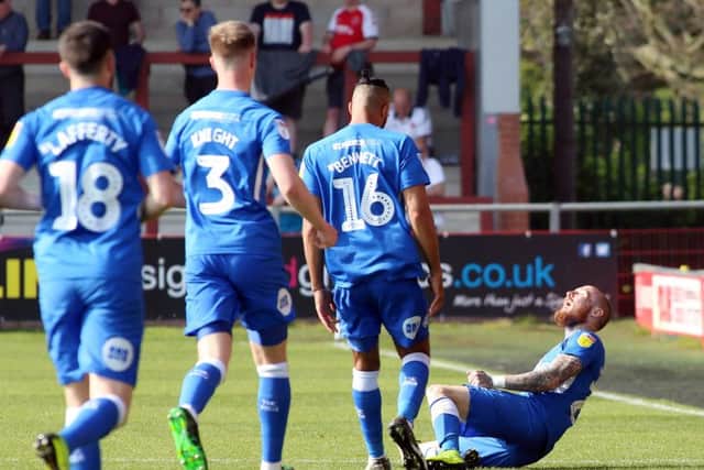 Marcus Maddison (on floor) celebrates his goal for Posh at Fleetwood. Photo: Joe Dent/theposh.com.