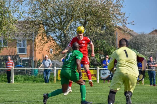 Mark Jones heads home the opening goal for Peterborough Sports at Kidlington. Photo: James Richardson.
