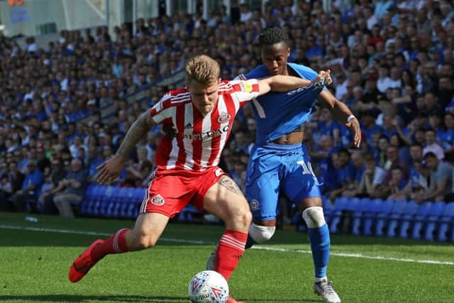 Siriki Dembele of Peterborough United battles for possession with Max Power of Sunderland. Photo: Joe Dent/theposh.com.