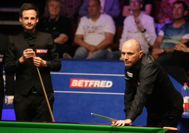 Joe Perry (right) and David Gilbert during day three of the 2019 Betfred World Championship at The Crucible.