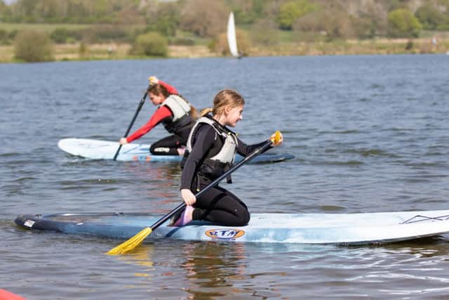 Sisters Katie (11) and Elsey (8) paddleboarding at Nene Park. Photo: Terry Harris