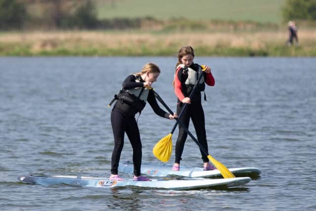 Sisters Katie (11) and Elsey (8) paddleboarding at Nene Park. Photo: Terry Harris