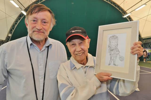 Club chairman Robert Brown handing Swee a caricature drawn of him