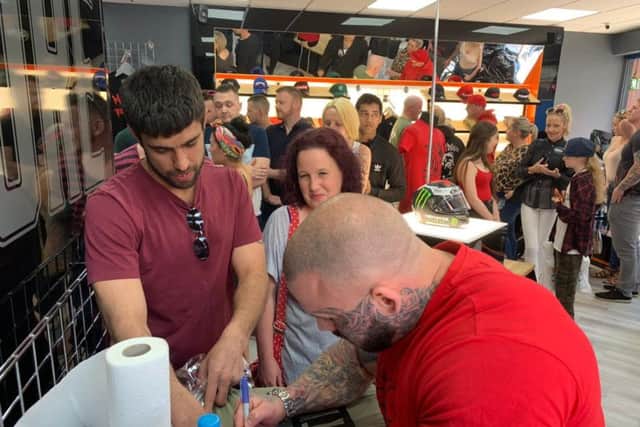 Aarron meeting fans inside his new shop