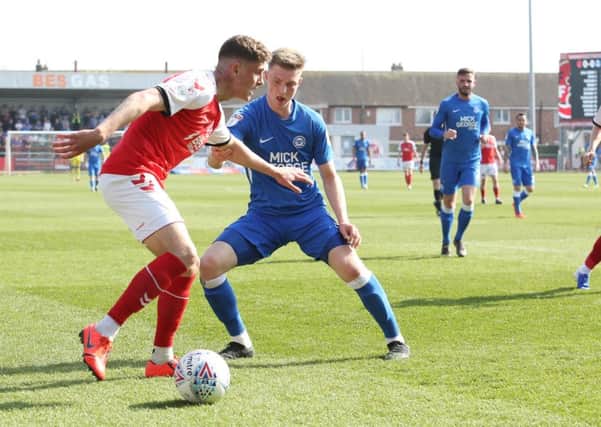 Josh Knight (blue) in action for Posh at Fleetwood.
