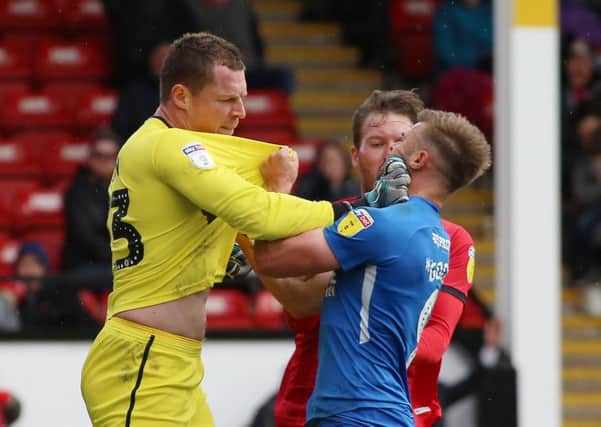 Tempers flare between Chris Dunn of Walsall and Matt Godden of Peterborough United. Picture: Joe Dent