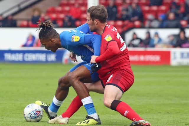 Ivan Toney of Peterborough United battles for possession with Scott Laird of Walsall. Photo: Joe Dent/theposh.com.