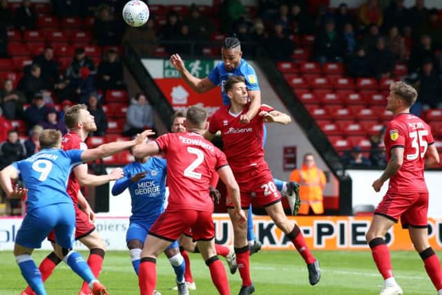 Posh centre-back Rhys Bennett wins a header at Walsall. Photo: Joe Dent/theposh.com.
