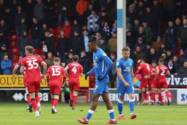 Ivan Toney of Peterborough United cuts a dejected figure as Walsall celebrate scoring. Photo: Joe Dent/theposh.com.