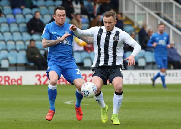 Lee Tomlin could be back in the Posh starting line-up at Portsmouth.
