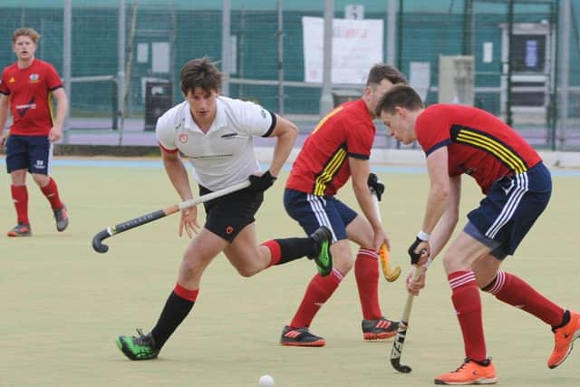 Action from the English Hockey Cup semi-final between City of Peterborough (red) and Bowden. Photo: David Lowndes.