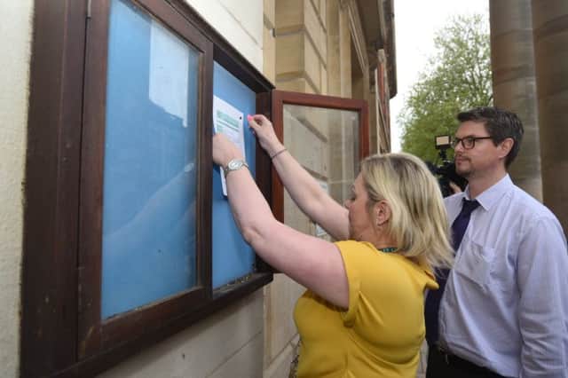 The notice of the Recall Petition being pinned outside the Town Hall